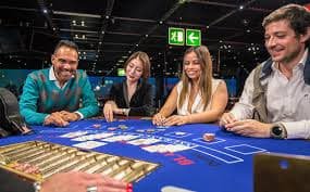 Roulette wheel spinning with live dealer managing bets in real time